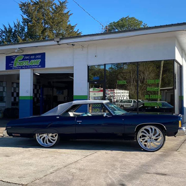 Dark Blue Vintage Car at a Garage